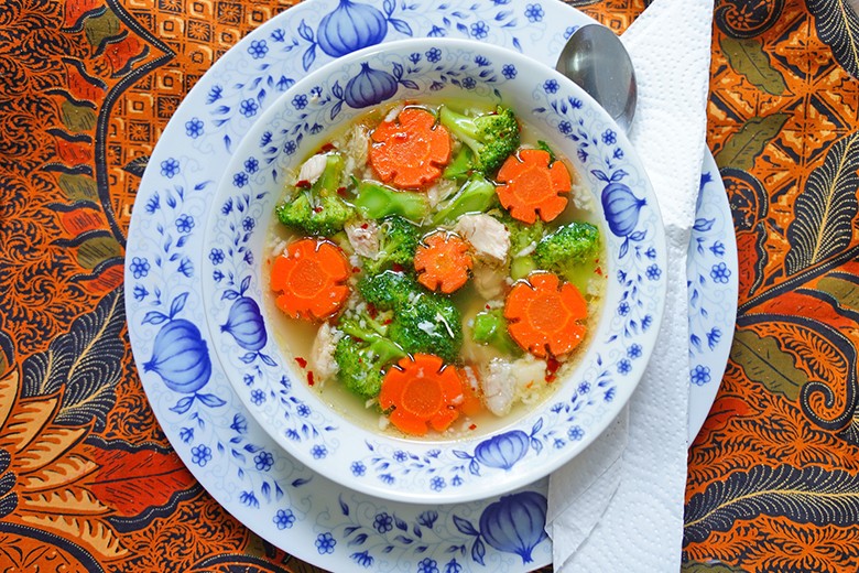 Klare Hühnersuppe mit Brokkoli und Karottenblumen