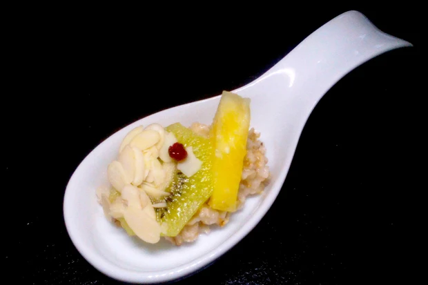 Warme Haferflocken mit Kiwi, Ananas, Mandelhobel und Preiselbeere